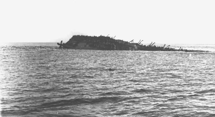 Men clinging to the upturned hull of Lancastria